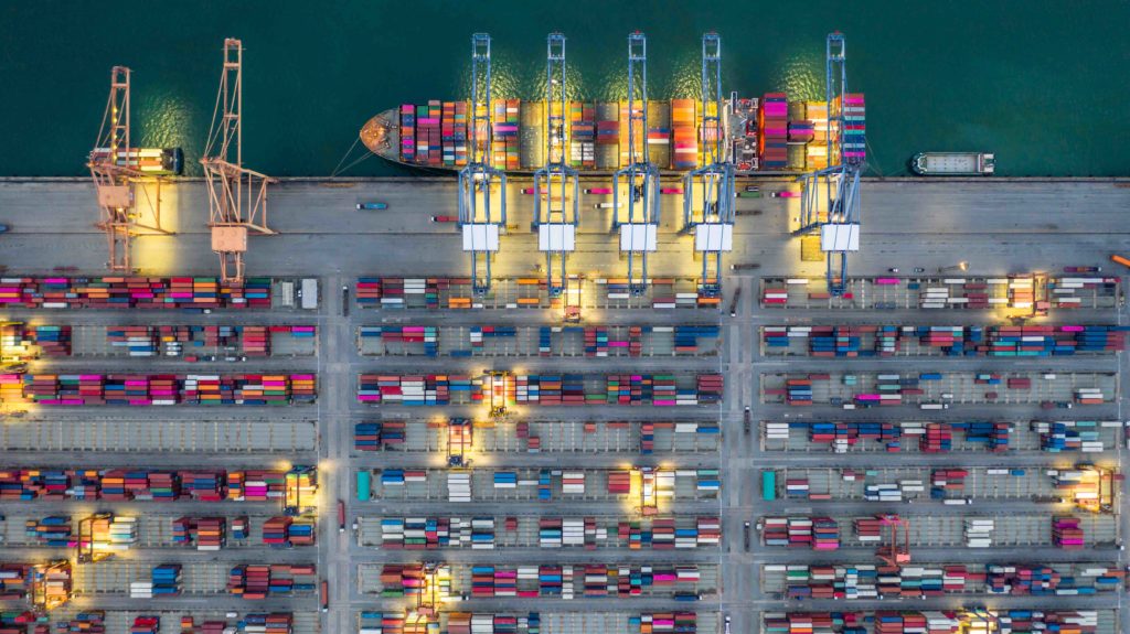 Aerial view of shipping containers at night docking in Dubai