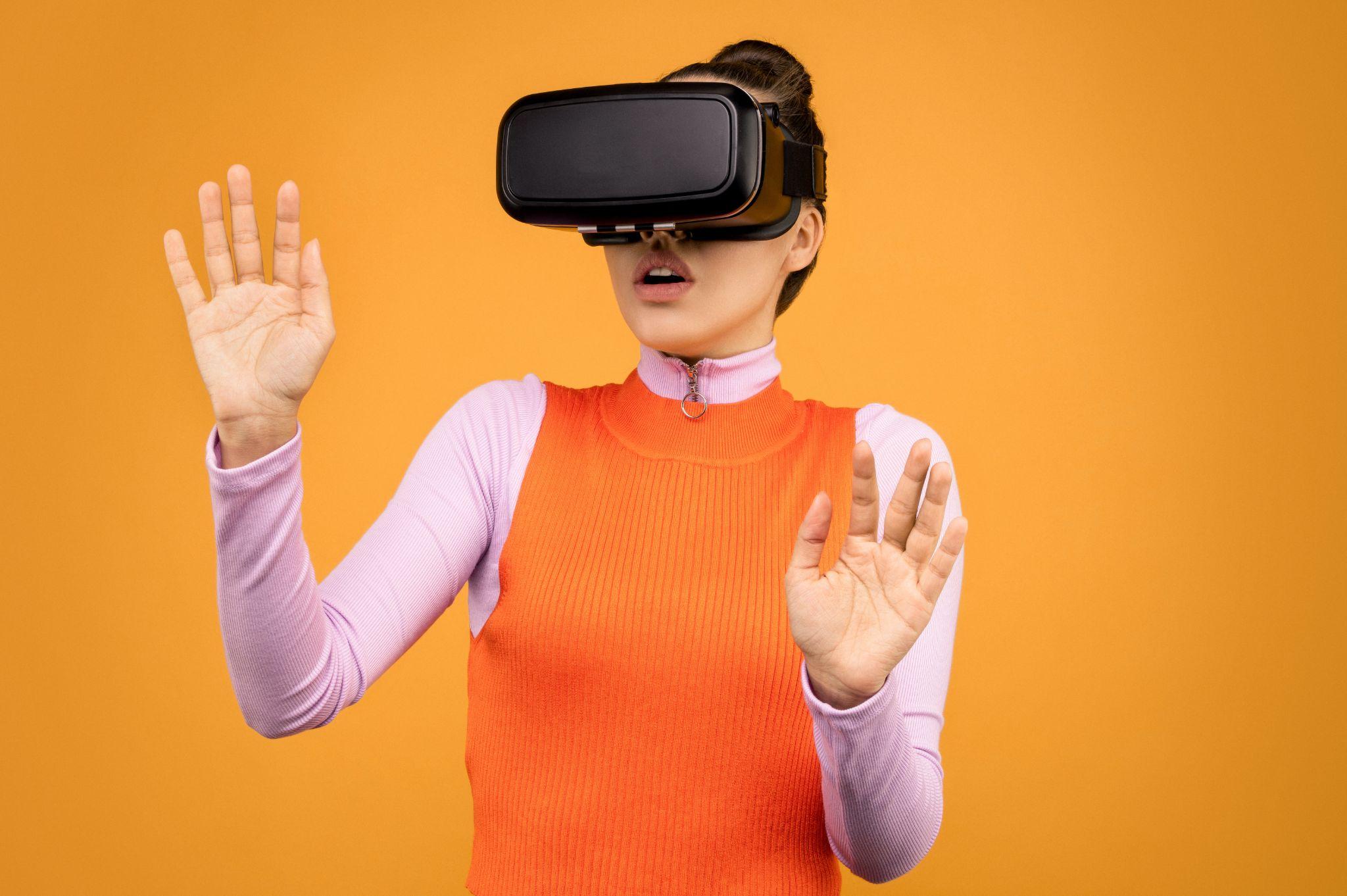 A photo of a woman using virtual reality headset.